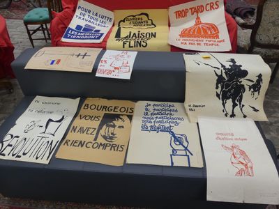 many t - shirts on display on a blue couch