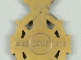 medals are displayed on a white surface with a red ribbon