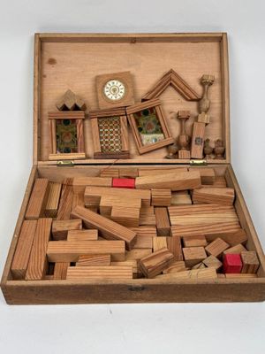 a wooden box filled with wooden blocks and a clock