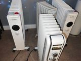 many white radiators that are lined up in a room