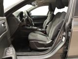 the interior of a car with the door open and the driver ' s seat down