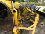 a yellow tractor that is sitting in the dirt