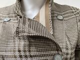 the jacket is brown and white checkered with buttons on the collar