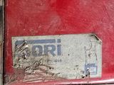 a red box with a sticker on it sitting on the ground