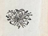 an old book with a bunch of flowers on top of it