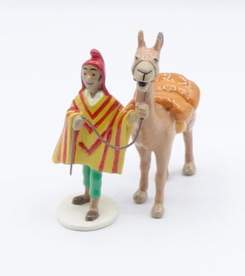 a figurine of a man and a donkey on a white surface