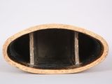 a close up of a black and gold vase