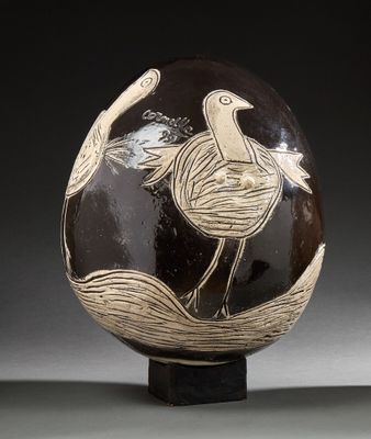 a black and white vase with a bird on it