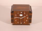 a small wooden clock that is sitting on a table