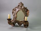 a mirror with a candle holder and a candle on it