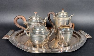 a silver tray with a silver tea set on it
