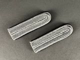 a pair of mop pads on a table with a gray background