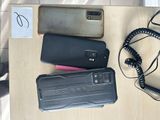 several cell phones are sitting on a table next to a phone charger