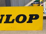 a yellow sign that says unlop on the side of a building