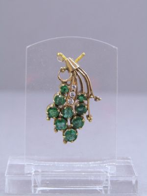 an image of a close up of a pair of earrings on a clear stand