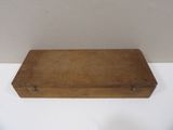 an old wooden box sitting on top of a white table