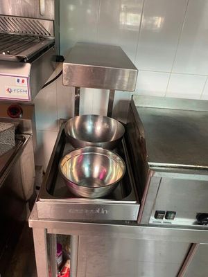 une cuisinière en acier inoxydable équipée de deux récipients