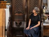 a woman that is sitting in a chair in a room