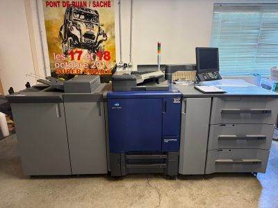 a blue and gray printer sitting on a desk in a room