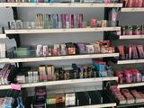 a lot of makeup products on the shelves in the store