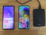 two samsung galaxy s10e smartphones next to each other on a wooden table