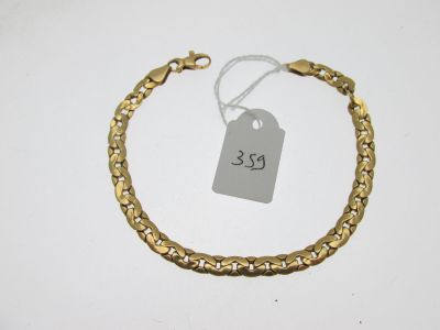 gros plan d'un bracelet en or portant une étiquette de prix