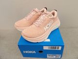 a close up of a pair of pink sneakers on a blue box