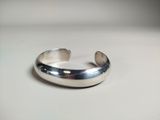 a close up of a silver ring on a white surface