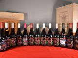 several bottles of wine are lined up on a table