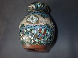 a picture of a decorative vase with a bird on it