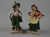 pair of figurines of a man and a woman dressed in traditional clothing