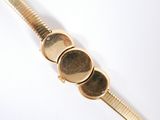 a close up of a gold bracelet with three coins on it