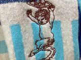 a blue and white striped sweater with a picture of a baby on it