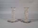 two clear glass candlesticks sitting on top of each other