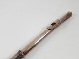 an old silver pipe sitting on top of a white table