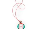 a close up of a necklace on a string with a pink cord