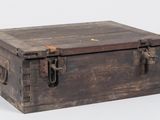 an old wooden box with a latch on it