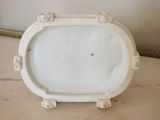 a white plate on a table with a gold frame