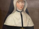 painting of a nun holding a book and a cross