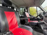 a red and black seat cover in the back of a truck