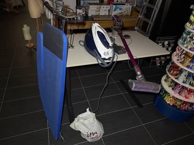 a blue and black iron on a table in a store