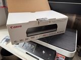 a printer sitting on top of a box on a table