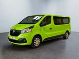 the green van is parked in a large room