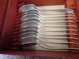 a lot of spoons and forks in a red box