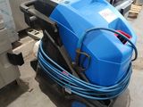 a blue machine that is sitting on the floor