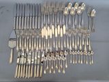 a lot of forks and spoons on the table