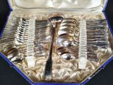 a silverware set in a blue case on a black table