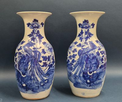 pair of blue and white vases with figures on them