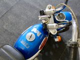 a blue motorcycle that is parked on the street