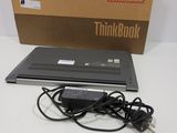 a laptop that is sitting on a table with a box in the background